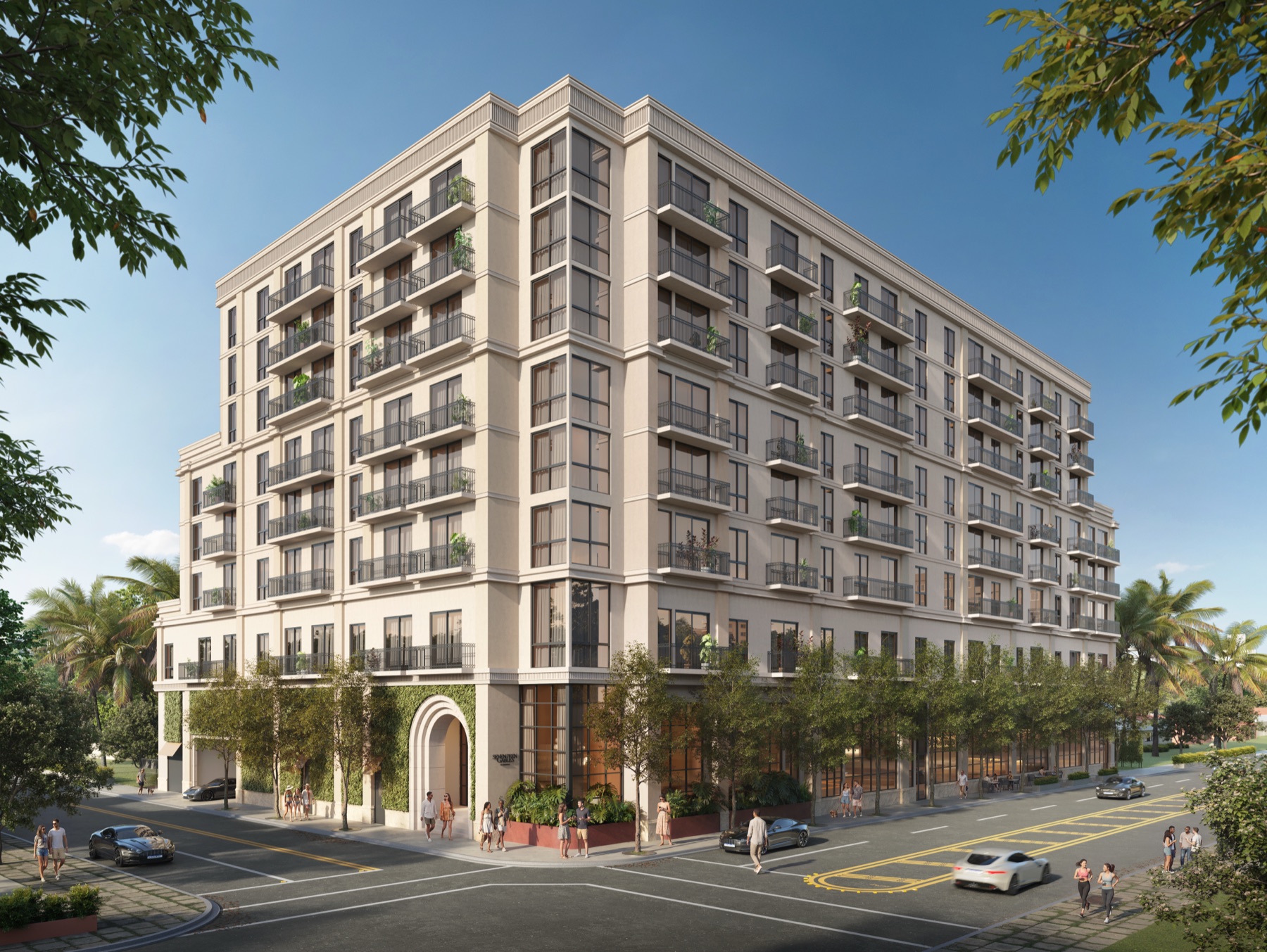 Seventeen Gables — the warm limestone façade of the eight-story Coral Gables tower at 1715 Douglas Road, with classical detailing, juliet balconies, an arched arrival, and a tree-lined street. Architecture and interiors by Asprea Studio.